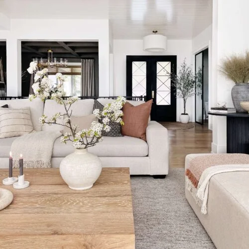 Living room with white couch and wooden coffee table.
