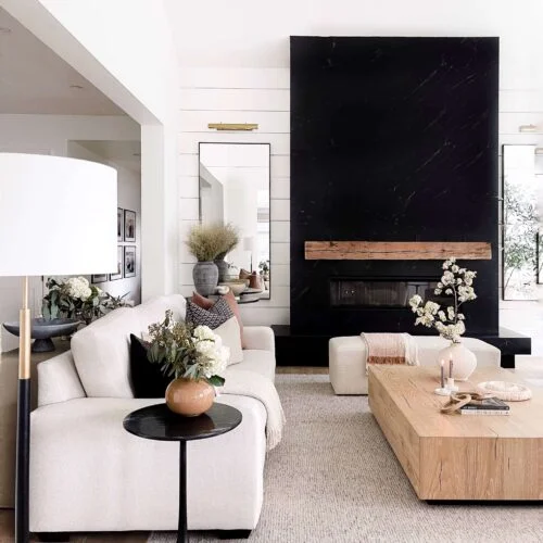 Modern living room with fireplace and rug.