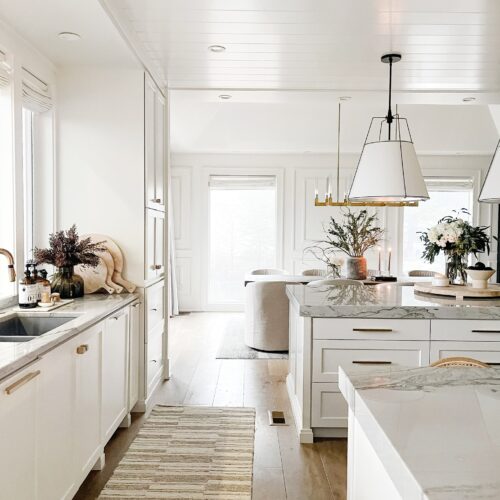 White kitchen with a runner rug.