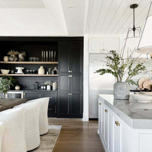 Modern kitchen with black and white cabinets.