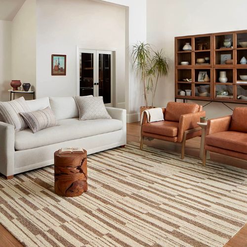 Living room with white couch and rug.