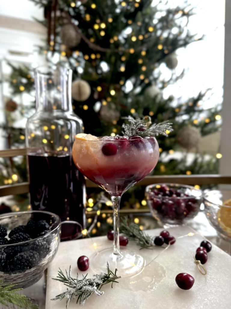 Cranberry and rosemary cocktail on table.