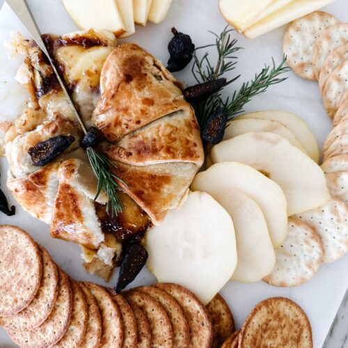 Baked brie with pears, crackers, and figs.