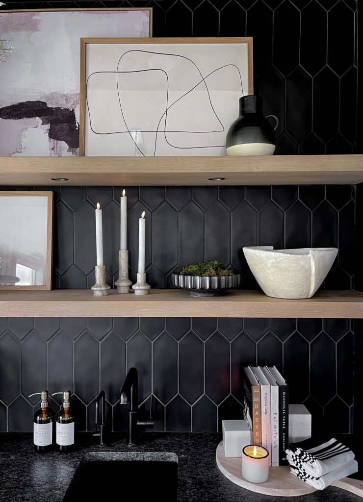 Black hexagon tile kitchen with shelves and decor.