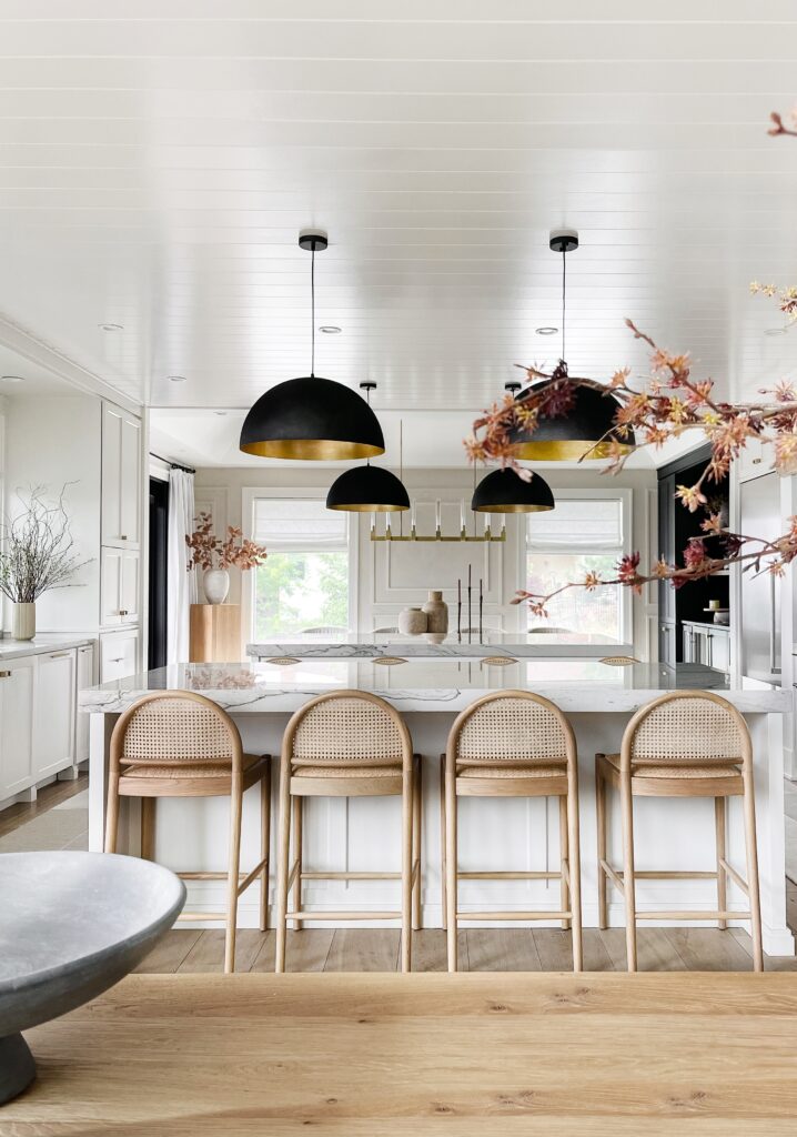 Kitchen island with gold and black lights.