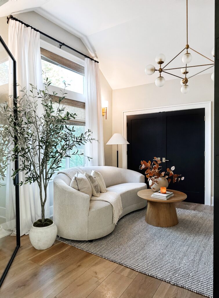 Modern living room with white couch and rug.