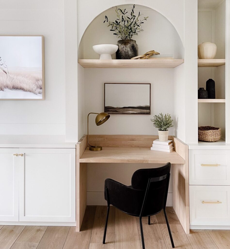 White and wood home office desk with black chair.