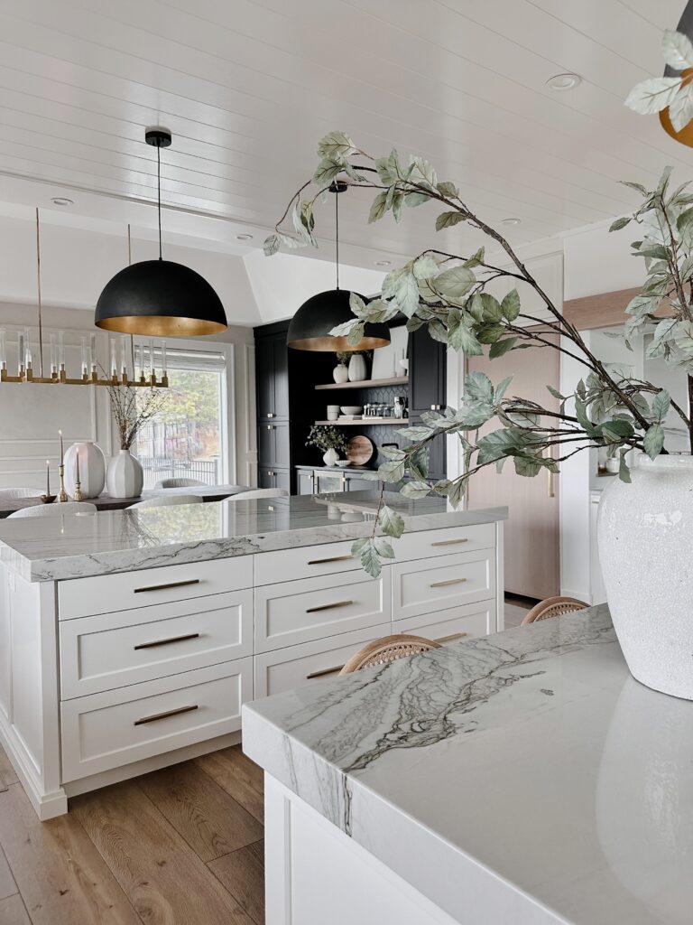 White kitchen island with marble countertop.