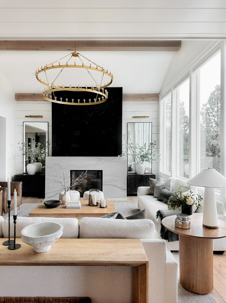 Modern living room with fireplace and chandelier.