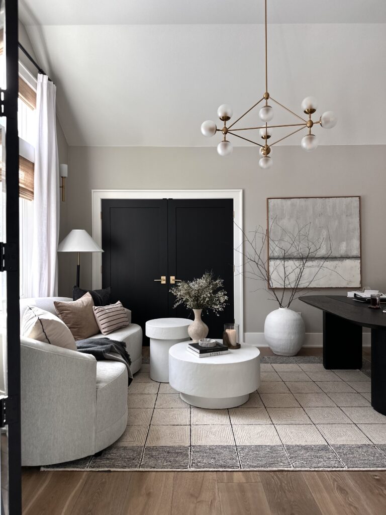 Modern living room with a white sofa and rug.