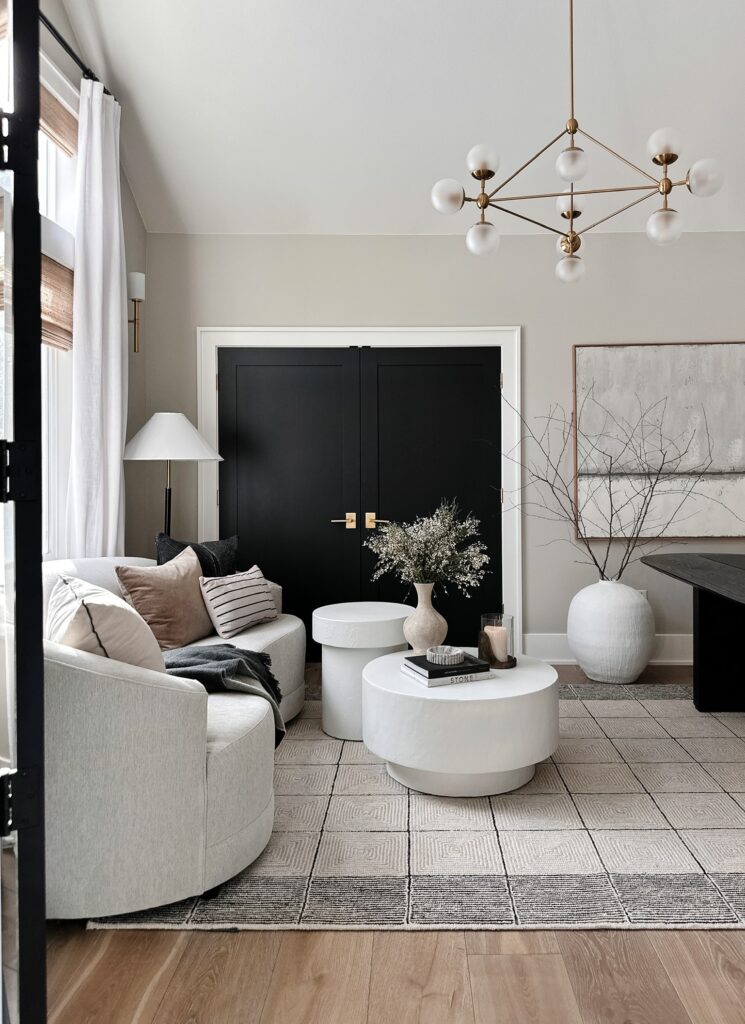 Modern living room with white couch and rug.