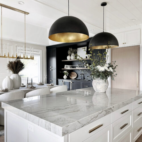 White kitchen island with marble countertop.