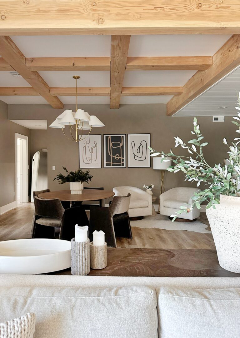 Modern living room with wood beams and art.