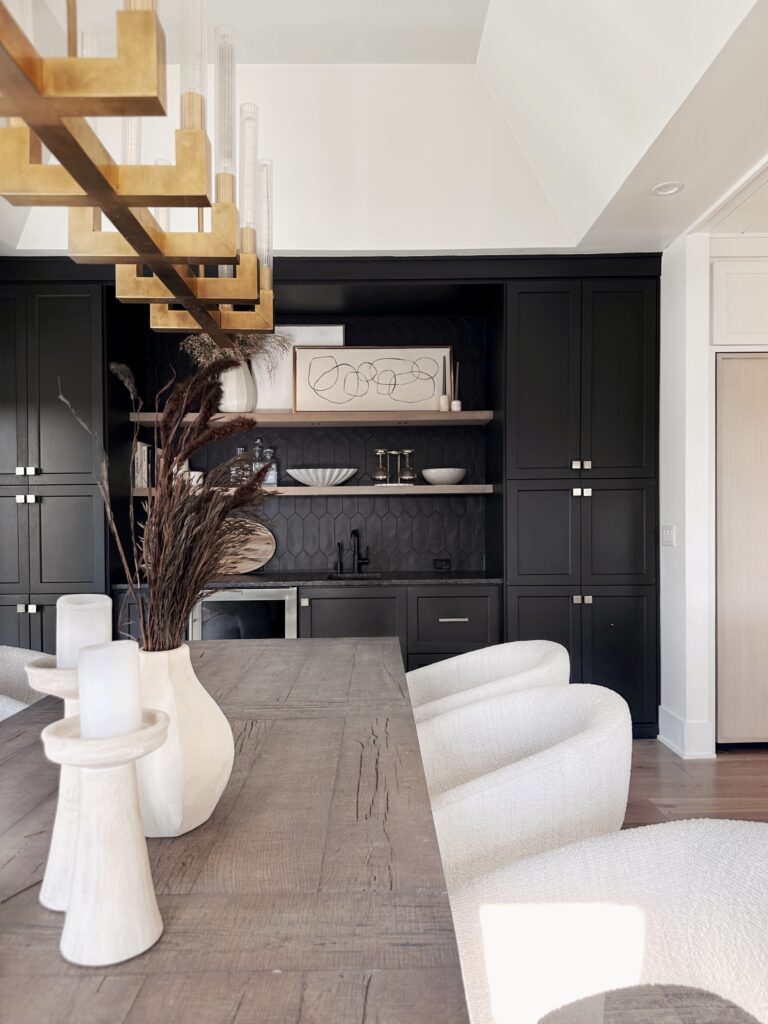 Modern dining room with black cabinets.