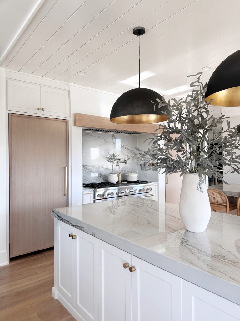 White kitchen island with gold accents.