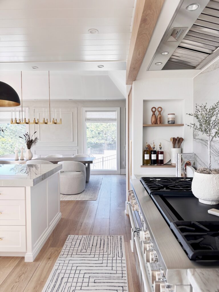 Modern kitchen with white cabinets and a gas stove.