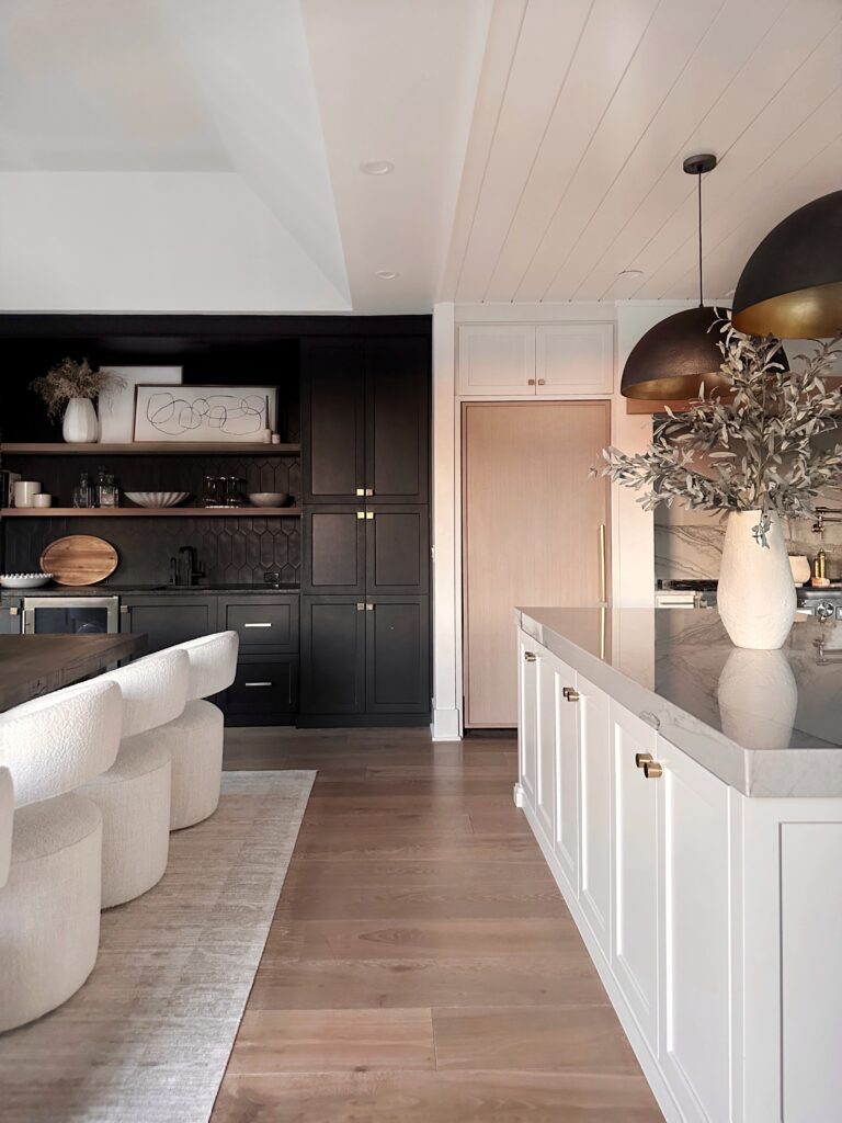 Modern kitchen with white cabinets and rug.