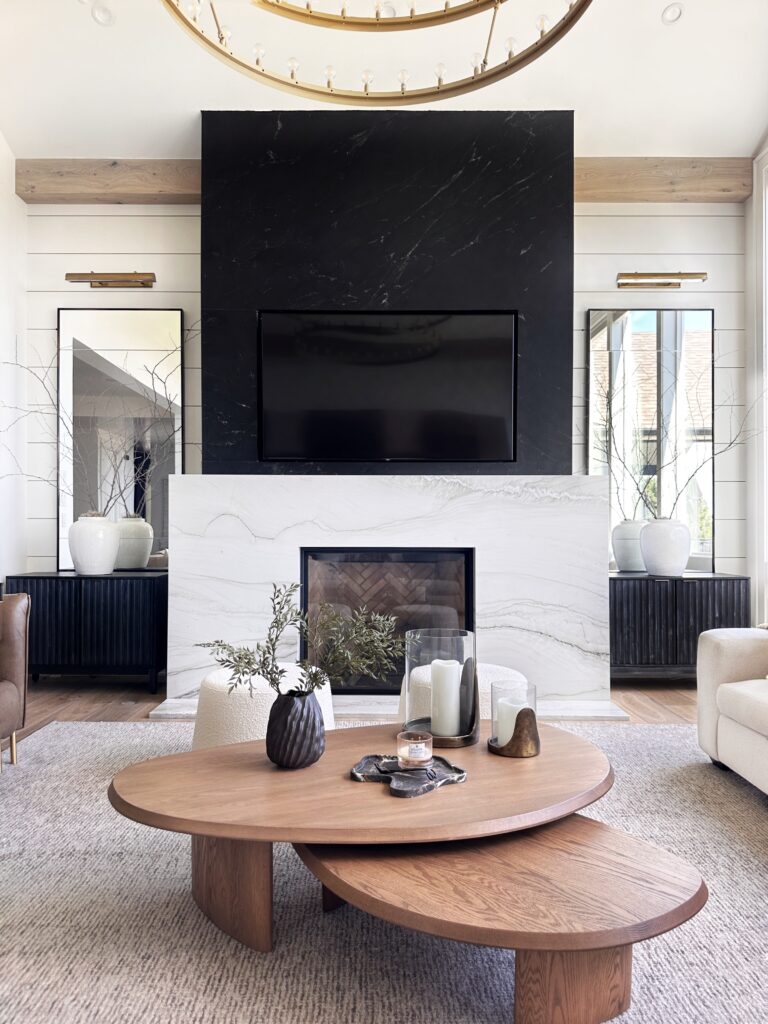 Modern living room with fireplace and coffee table.