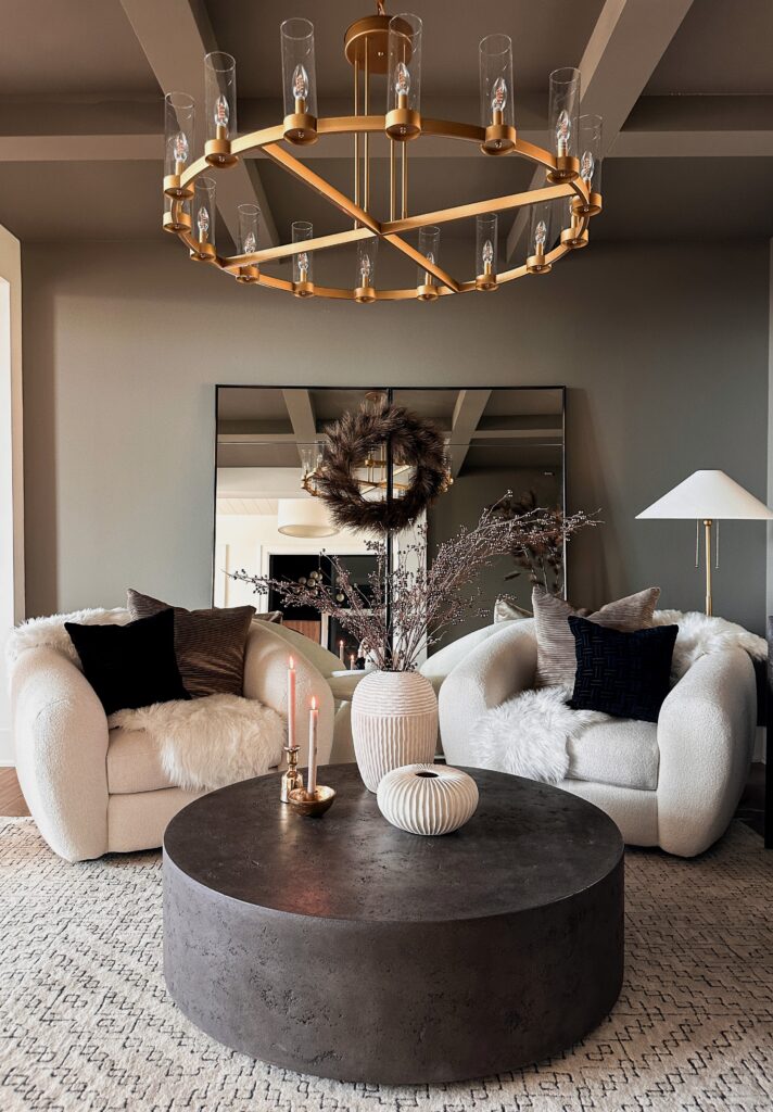 A living room with a round coffee table.