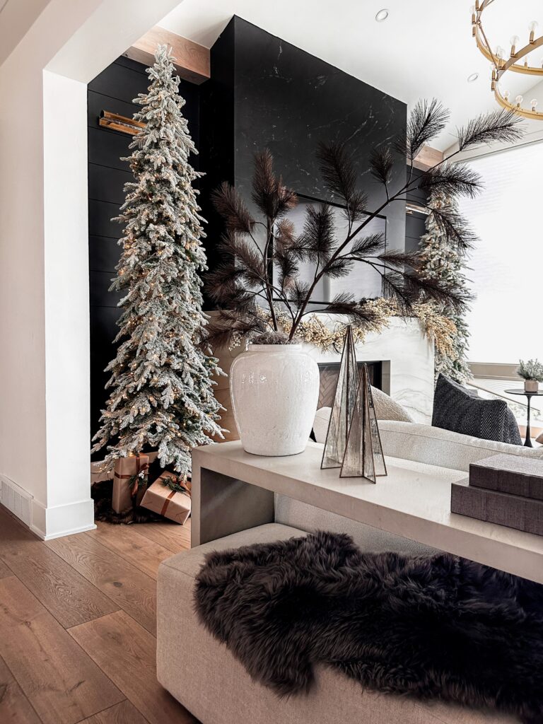 Frosted Christmas tree in modern living room.