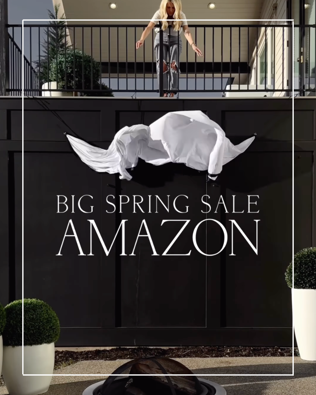 Amazon Big Spring Sale sign with woman on balcony.