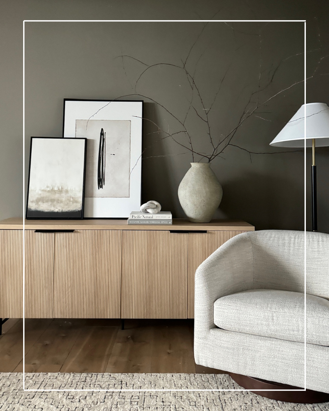 Minimalist living room with wood cabinet and chair.