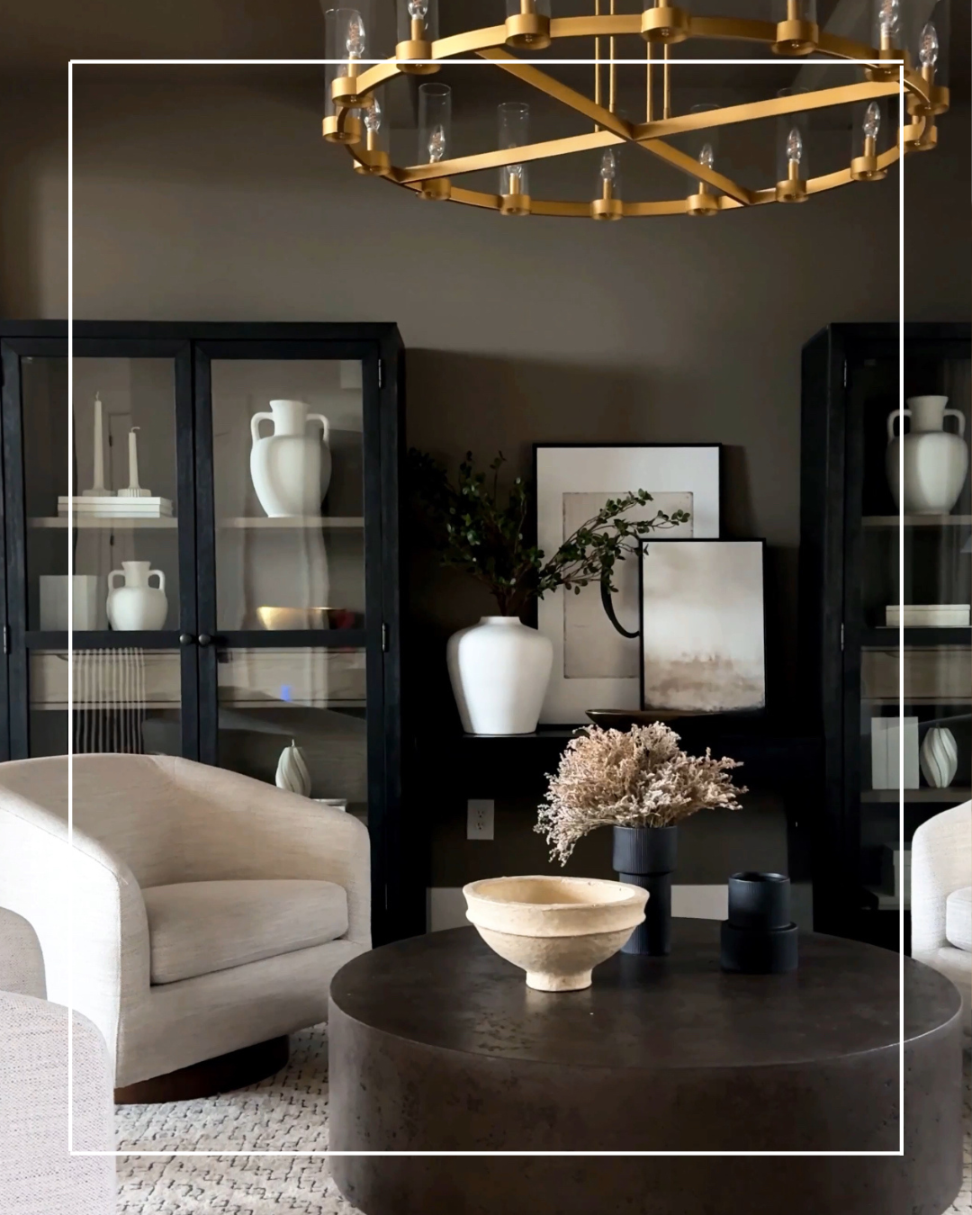 Living room with a round coffee table and chairs.