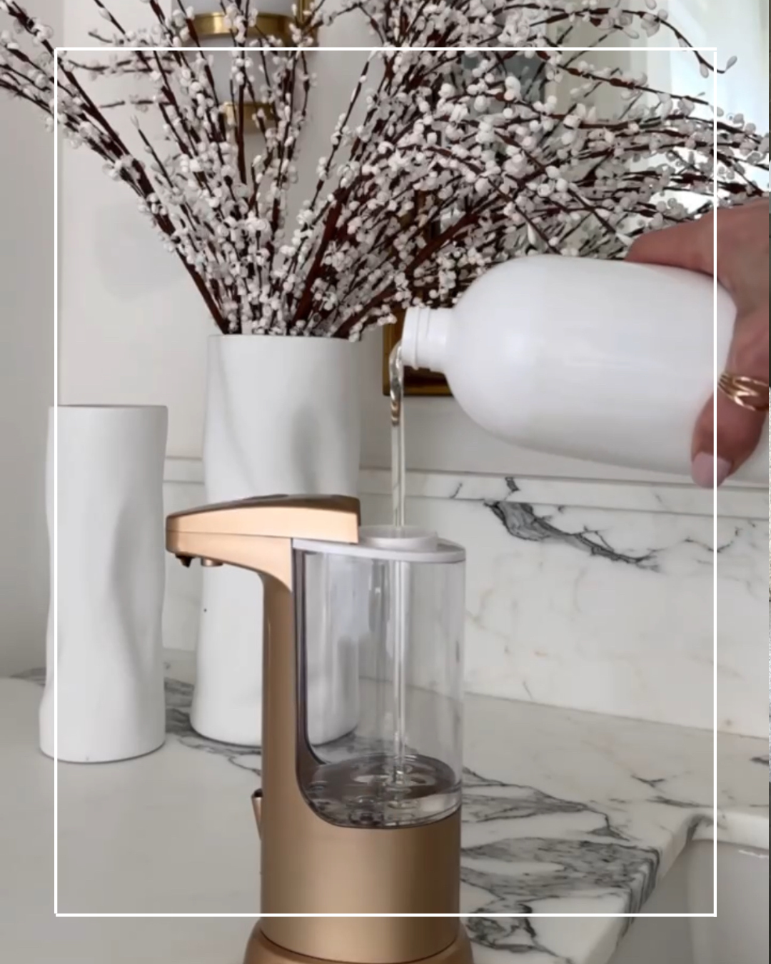 Hand soap dispenser being filled with liquid.