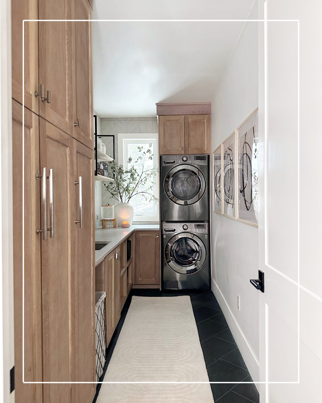 Modern laundry room with stacked washer and dryer.