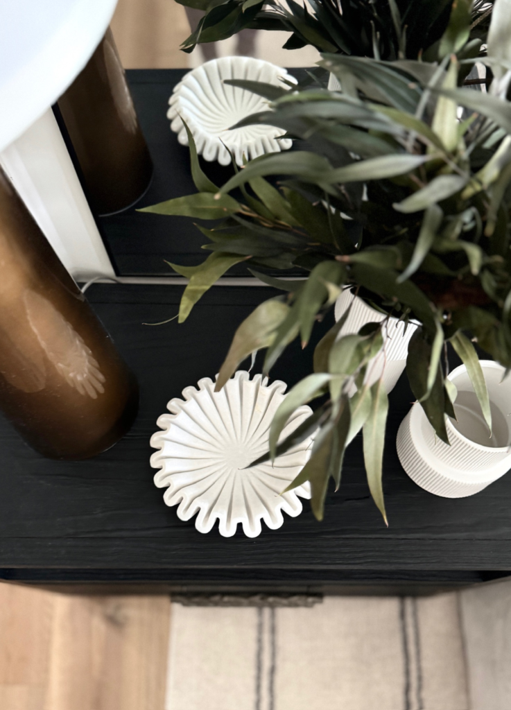 White decorative bowls and vase on table.